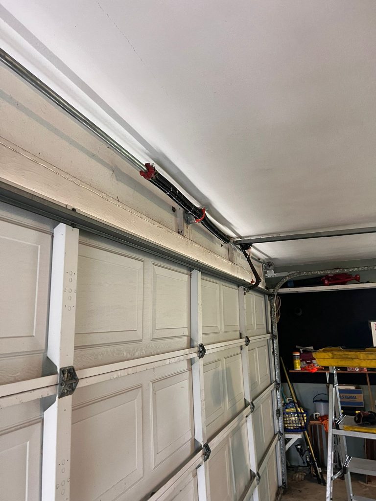 Garage Door Repair | Garage Door Repair Fort Myers 7 Garage door cables and tracks overhead in a residential garage, illustrating garage door repair and maintenance context.