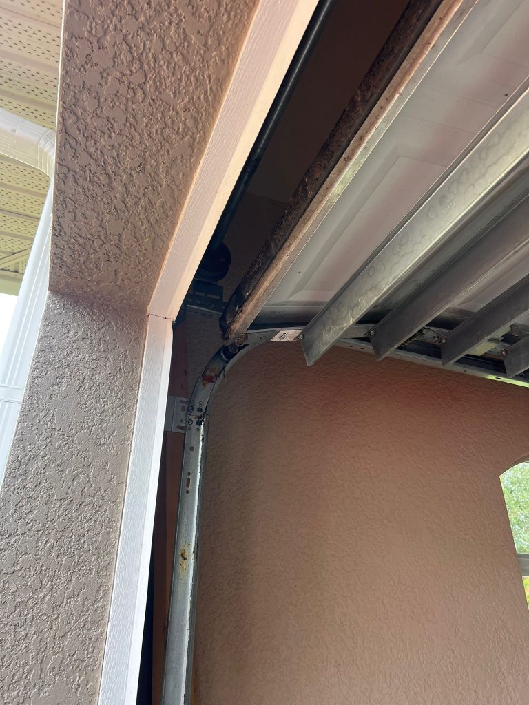 Garage Door Repair | Garage Door Repair Fort Myers 6 Garage door track and cable assembly showing wear, highlighting the need for professional garage door repair services in Fort Myers.